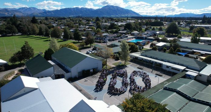 Ash1 MHC CENTENNIAL drone photo of current students celebrating